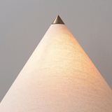 Conical lamp with a metallic top on a plain background