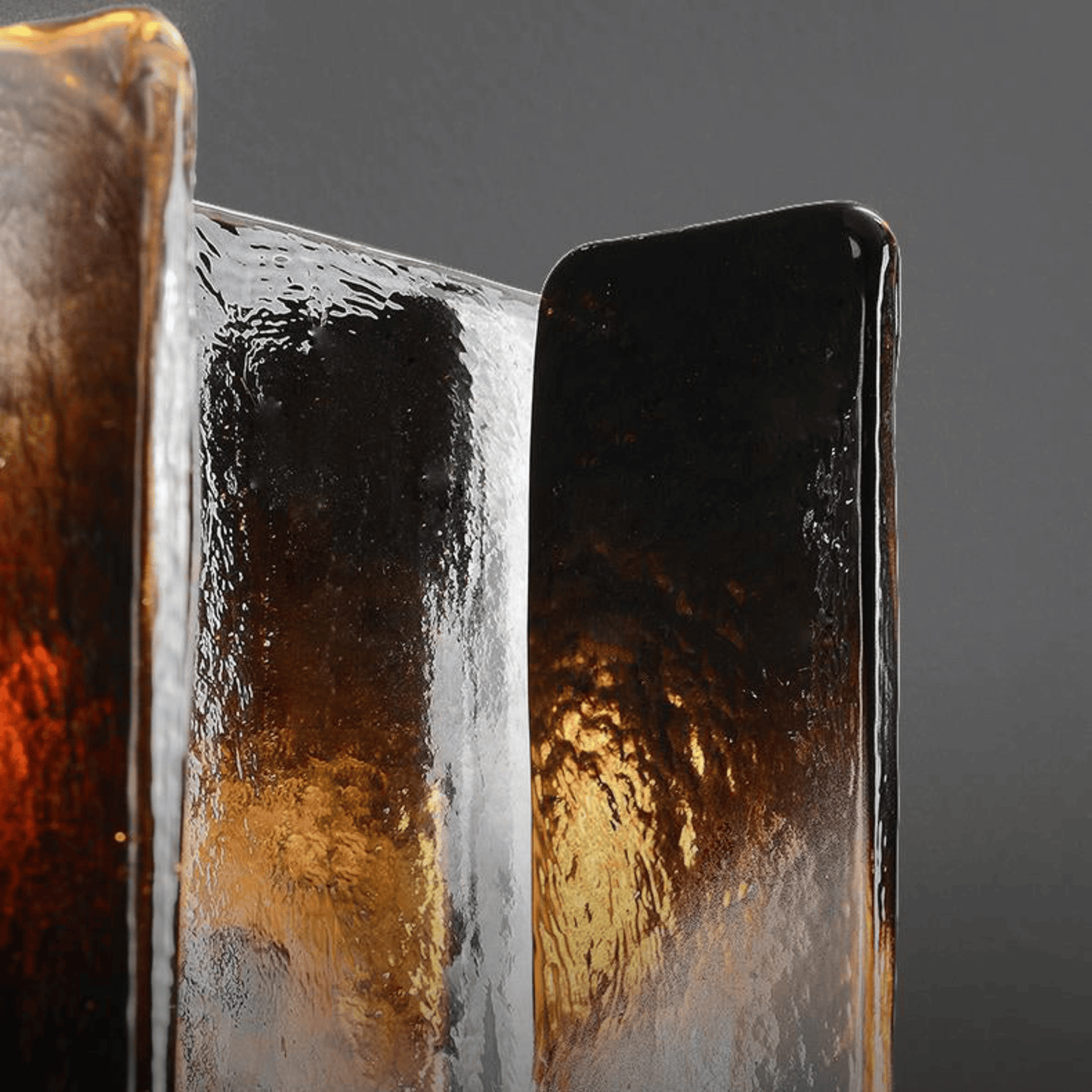 Close-up of a metallic object with reflective surface on a gray background