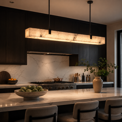 Modern kitchen with marble countertops and pendant lights