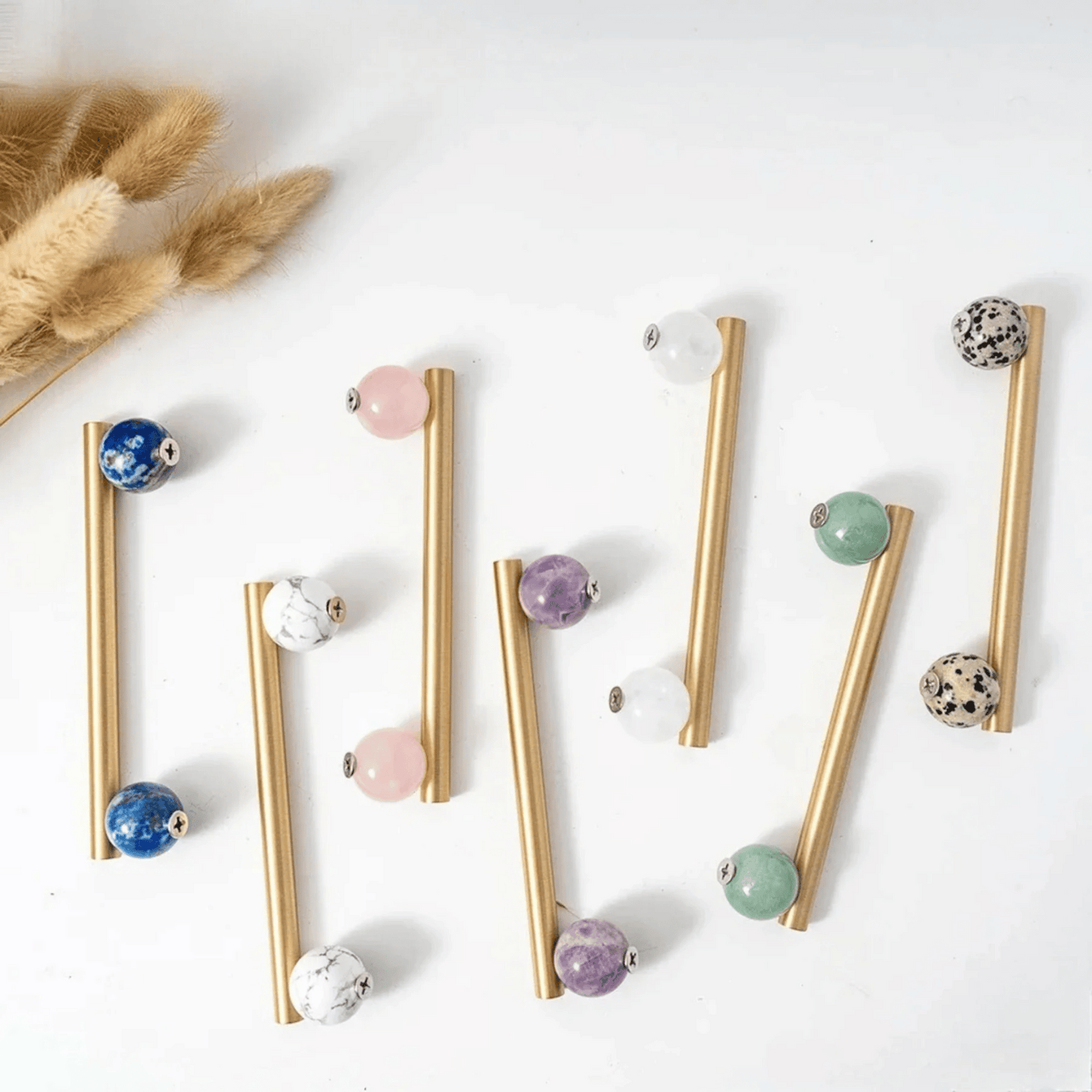 Gold straws with colorful beads on a white background