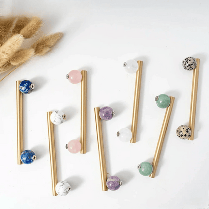 Gold straws with colorful beads on a white background