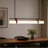 Modern pendant light over a dining table with decor items.