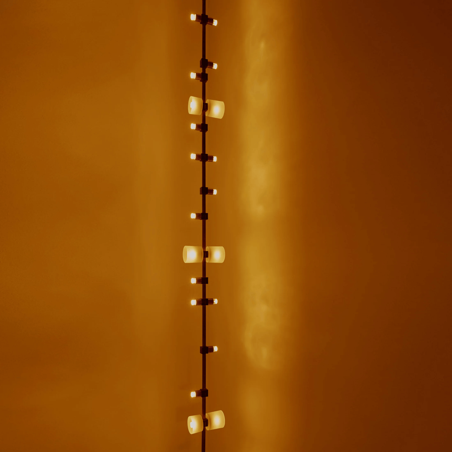String of lights against a warm orange wall