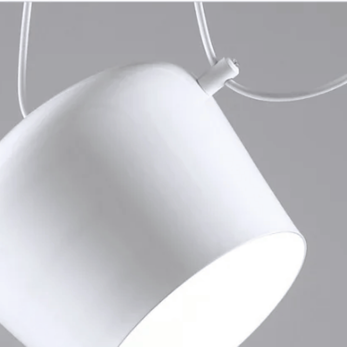 Close-up of a white pendant light against a gray background