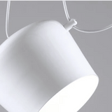 Close-up of a white pendant light against a gray background