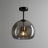 Modern ceiling light fixture with smoked glass shade and gold interior on a gray background