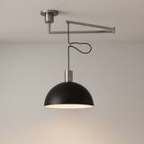 Ceiling-mounted lamp with black shade and metal arm on a neutral background