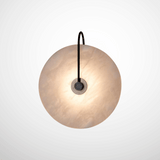 Spherical pendant light with a textured glass shade on a white background