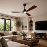 Modern living room with a ceiling fan, sectional sofa, coffee table, and TV.