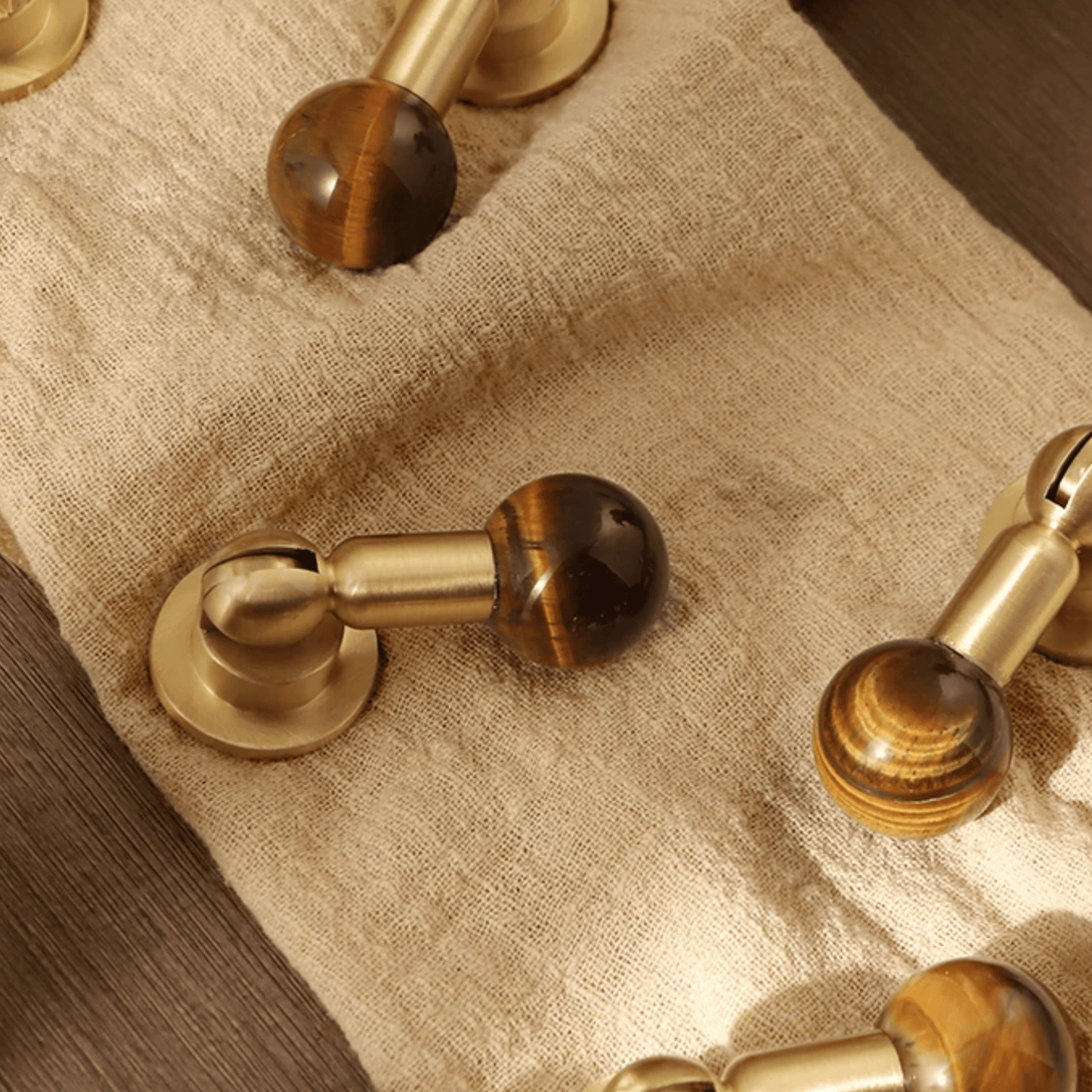 Close-up of gold and brown door handles on a textured surface