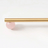 Gold curtain rod with a pink ball finial on a white background
