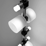 Modern chandelier with white glass shades on a gray background