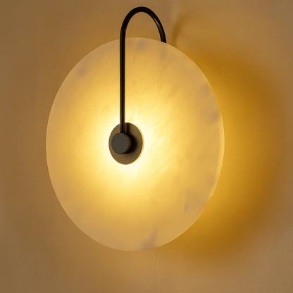 Wall-mounted light fixture with a spherical glass shade on a neutral background