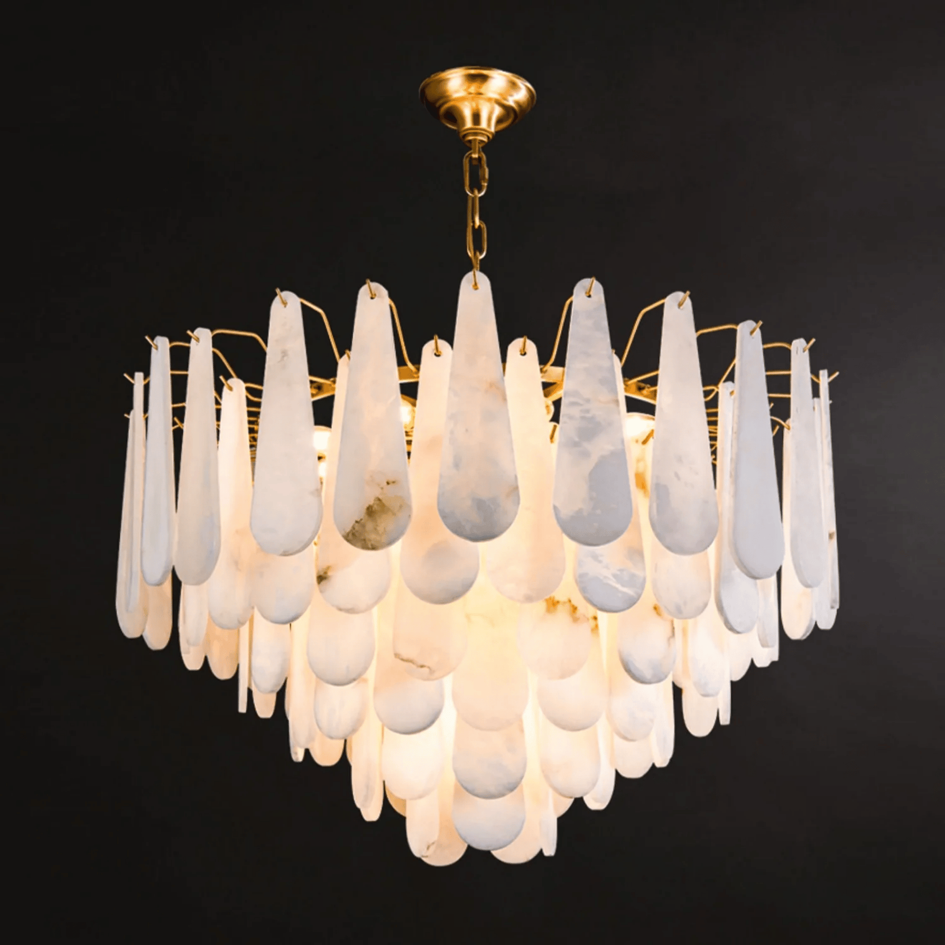 Chandelier with white teardrop-shaped glass shades on a black background