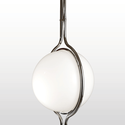 Chrome spoon with a white ceramic bowl on a light gray background