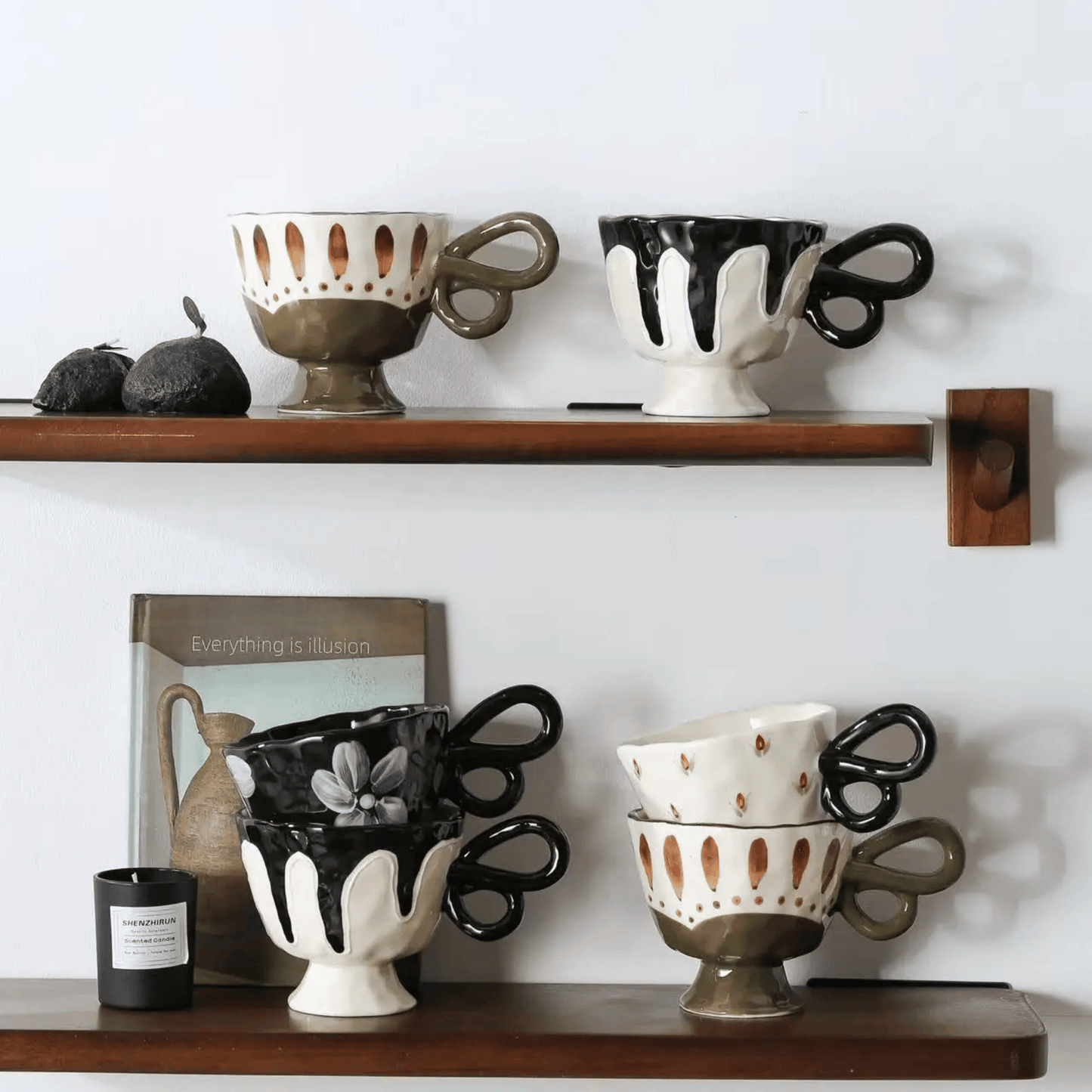 Decorative ceramic cups on wooden shelves against a white wall