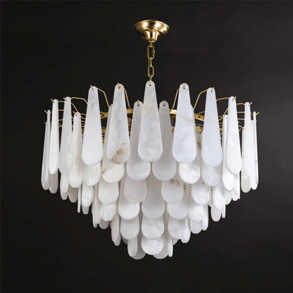Chandelier with white teardrop-shaped glass and gold fixture on a black background