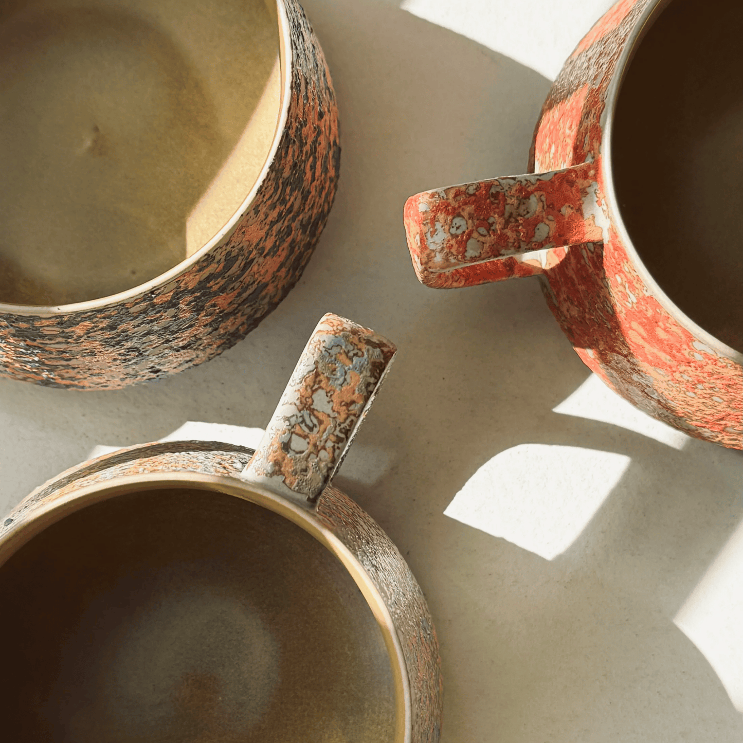 Three ceramic bowls with rustic textures on a light background