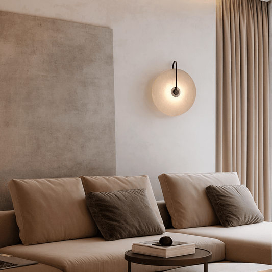 Modern living room with beige sofa, wall lamp, and curtains.