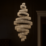 Chandelier with spiral design hanging against a dark background
