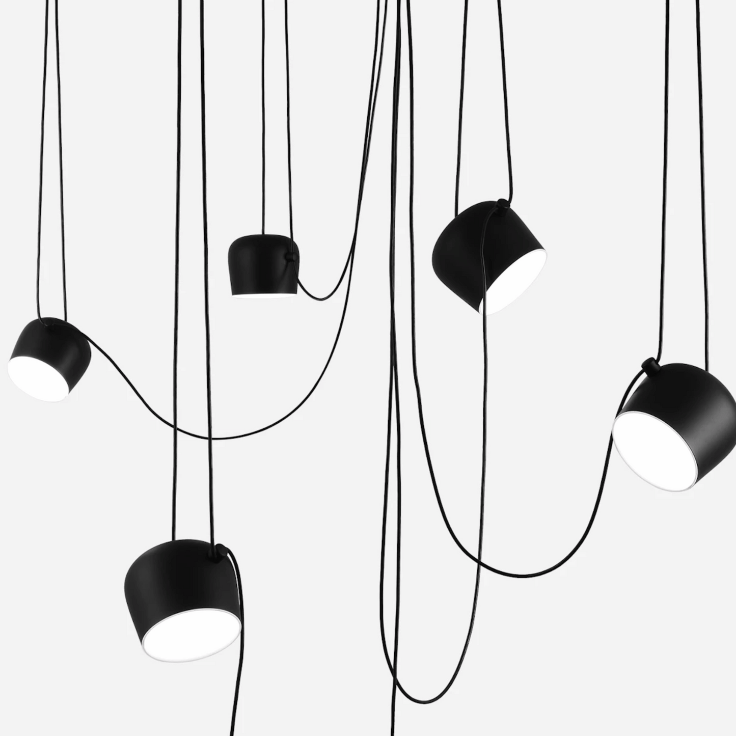 Black pendant lights with white bulbs on a white background