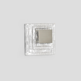 Single diamond earring on a white background