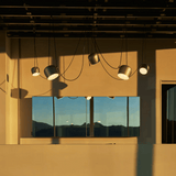 Modern ceiling lights on a beige wall with a reflective surface