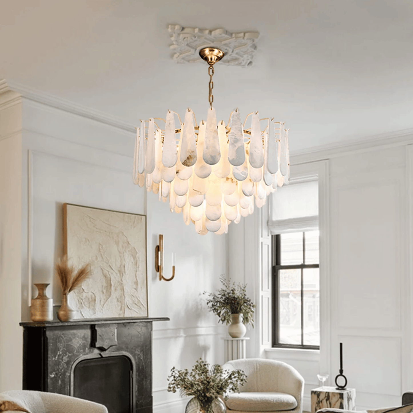Chandelier hanging in a living room with white walls and a fireplace.