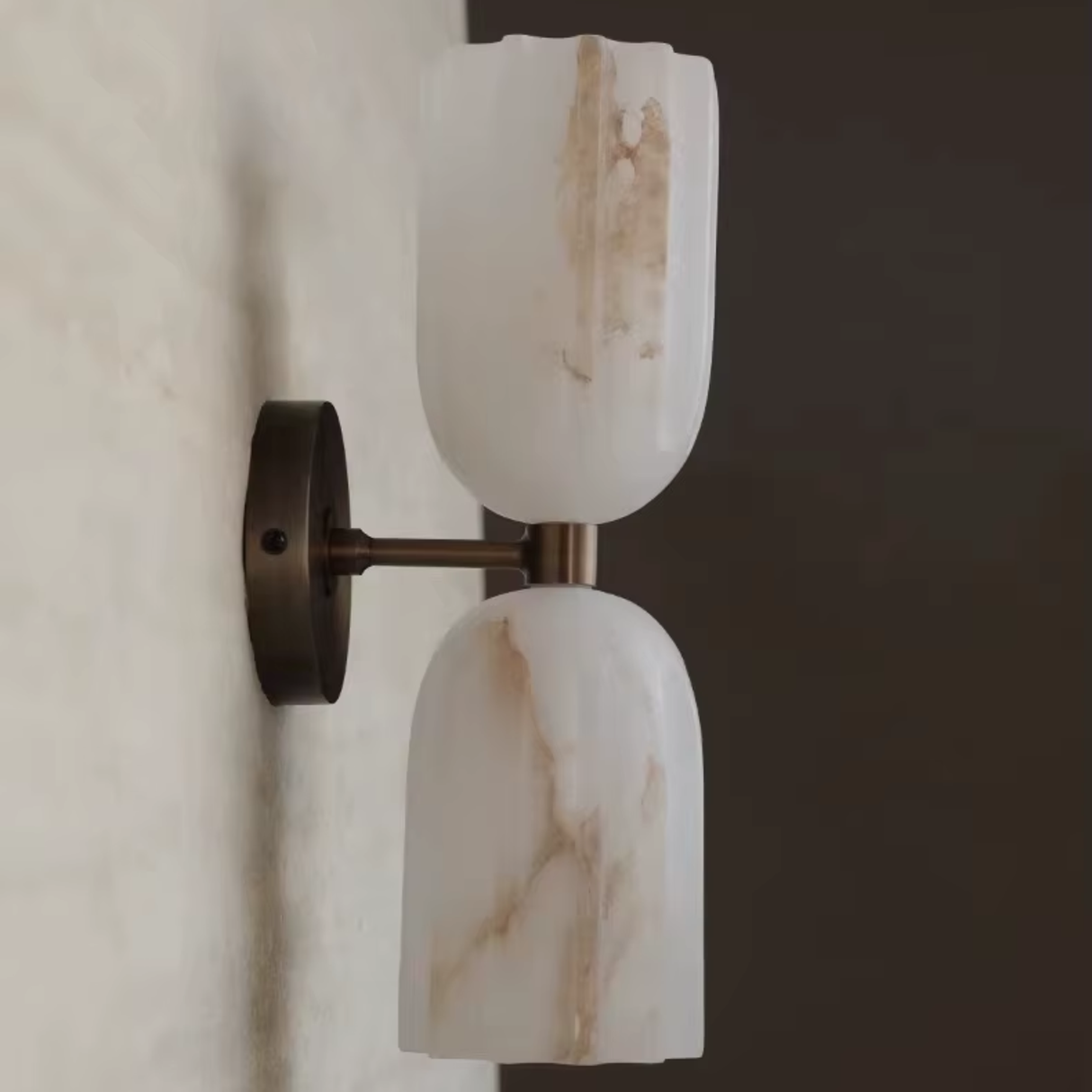 Wall-mounted light fixture with marble-like finish on a neutral background