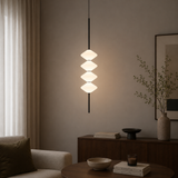 Modern pendant light fixture in a living room setting with a neutral color palette.
