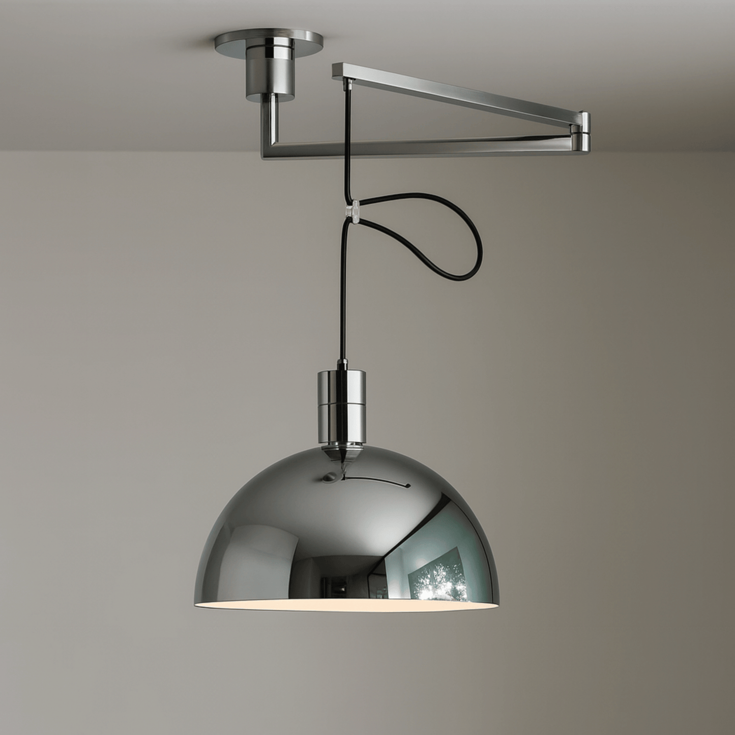 Modern pendant light with a metallic shade on a neutral background