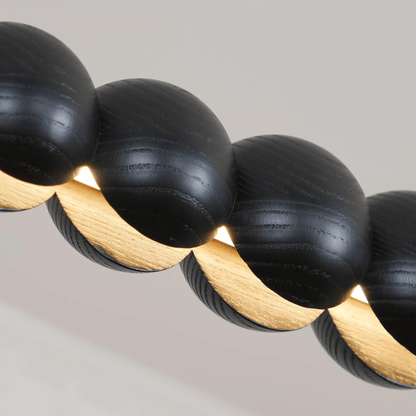 Close-up of black and gold beaded necklace on a neutral background