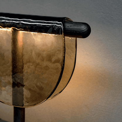 Close-up of a gong with a wooden handle on a neutral background