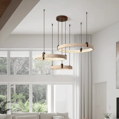 Modern pendant lights hanging in a living room with large windows.