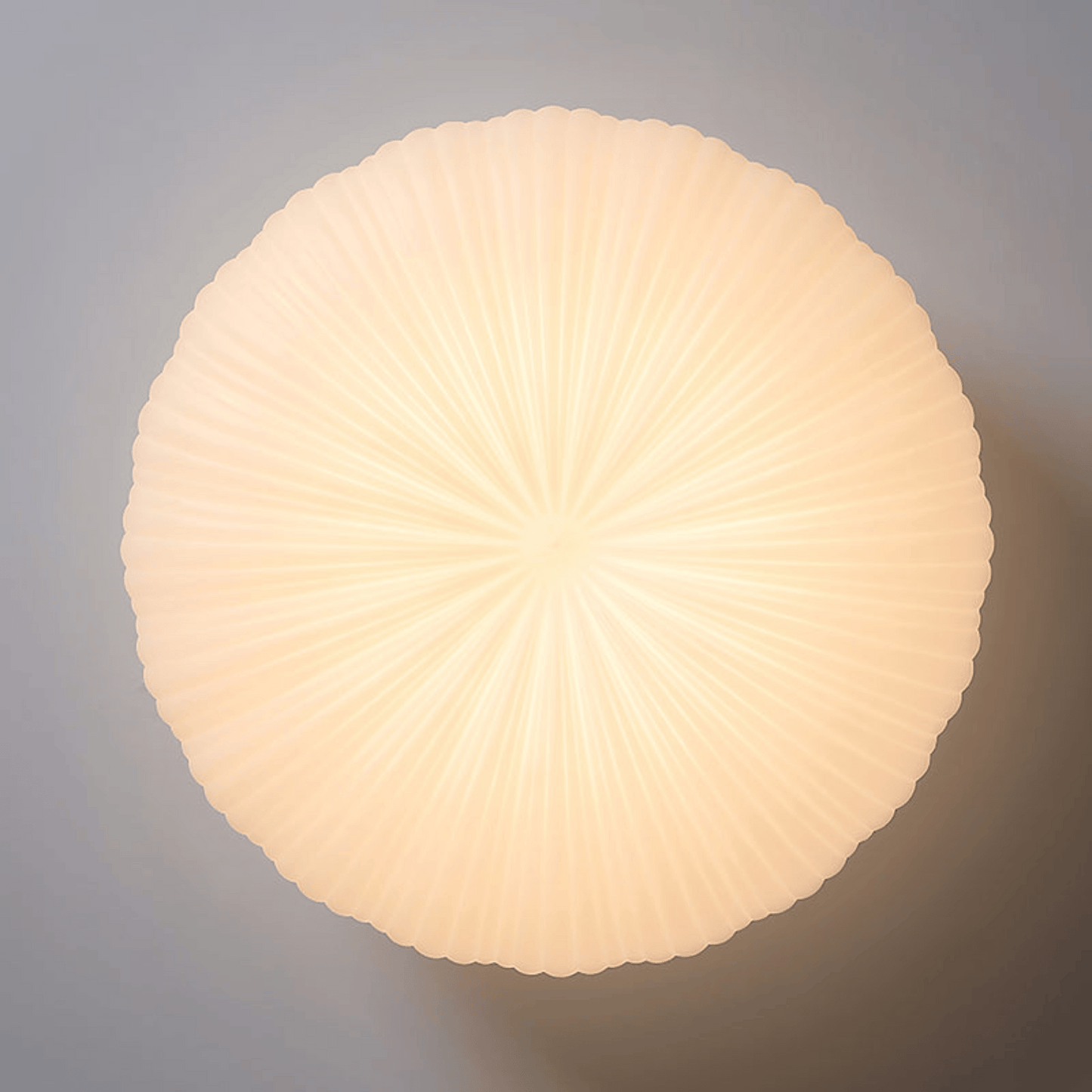 Round, ribbed light fixture on a gray background