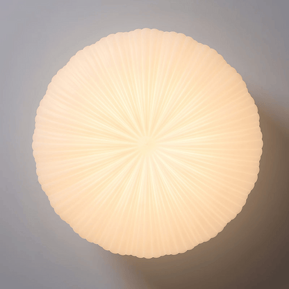 Round, ribbed light fixture on a gray background
