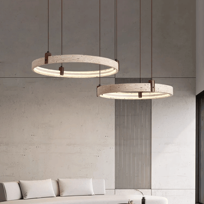 Two modern pendant lights hanging above a sofa in a living room setting.