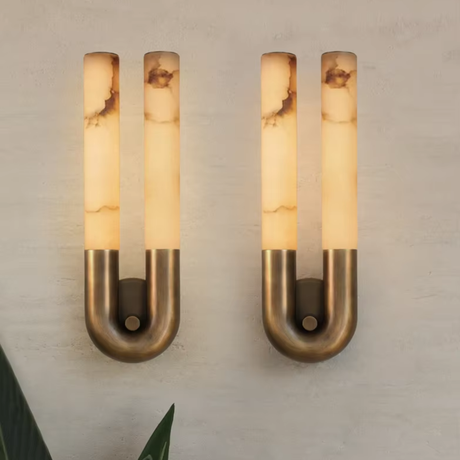 Pair of wall sconces with warm light on a neutral background