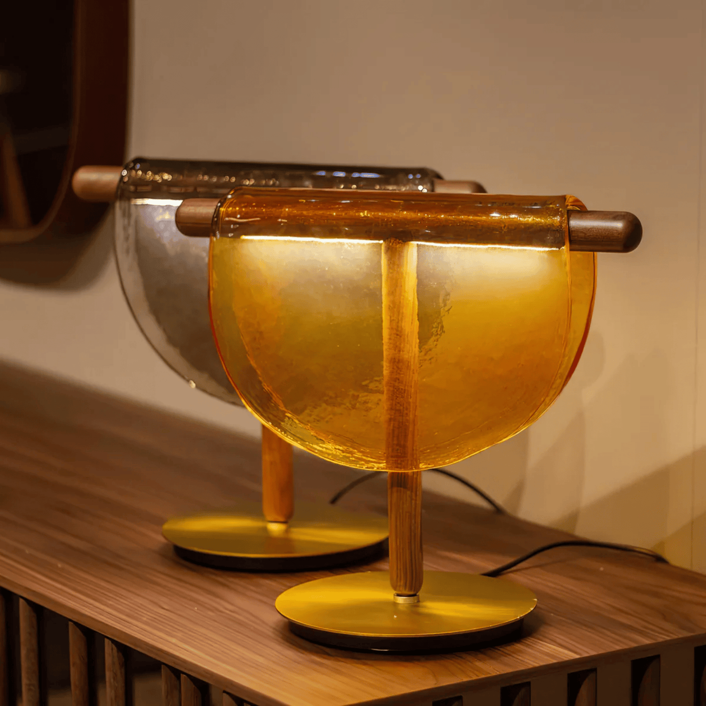Decorative lamp with amber glass shade on a wooden surface