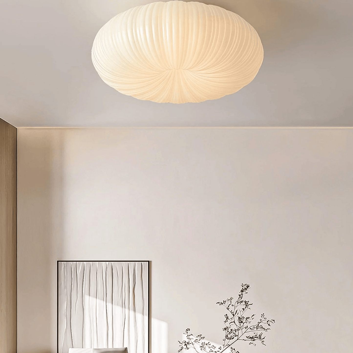 Ceiling light fixture in a room with a mirror and decorative plant