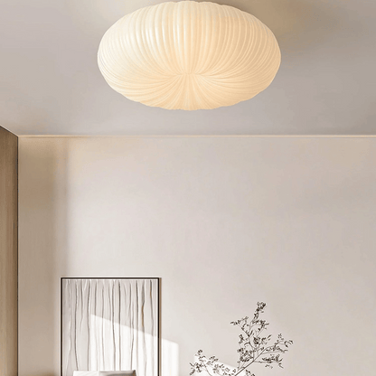 Ceiling light fixture in a room with a mirror and decorative plant