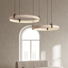 Two modern pendant lights hanging in a room with a neutral color scheme.