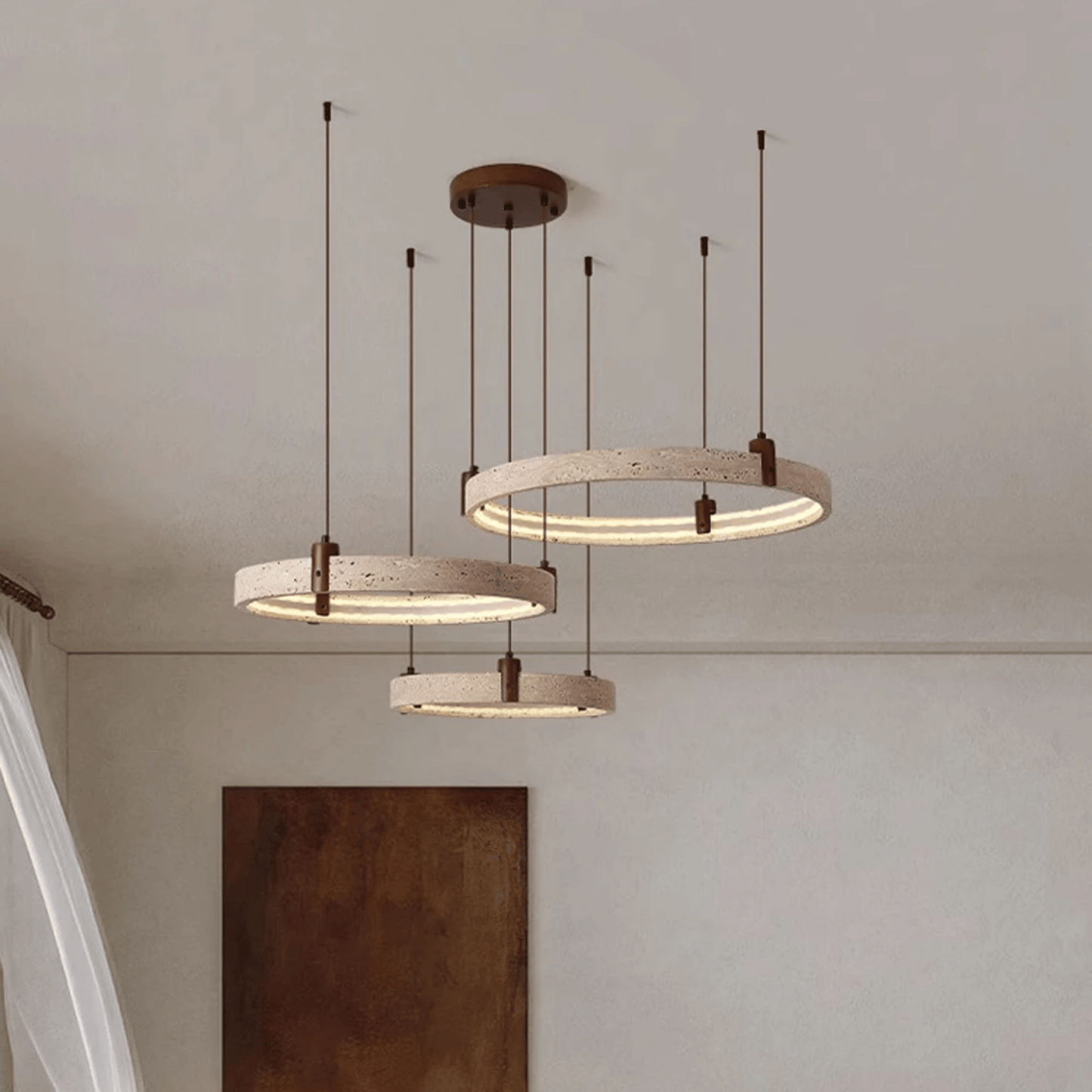Three circular pendant lights hanging from the ceiling with a neutral background.