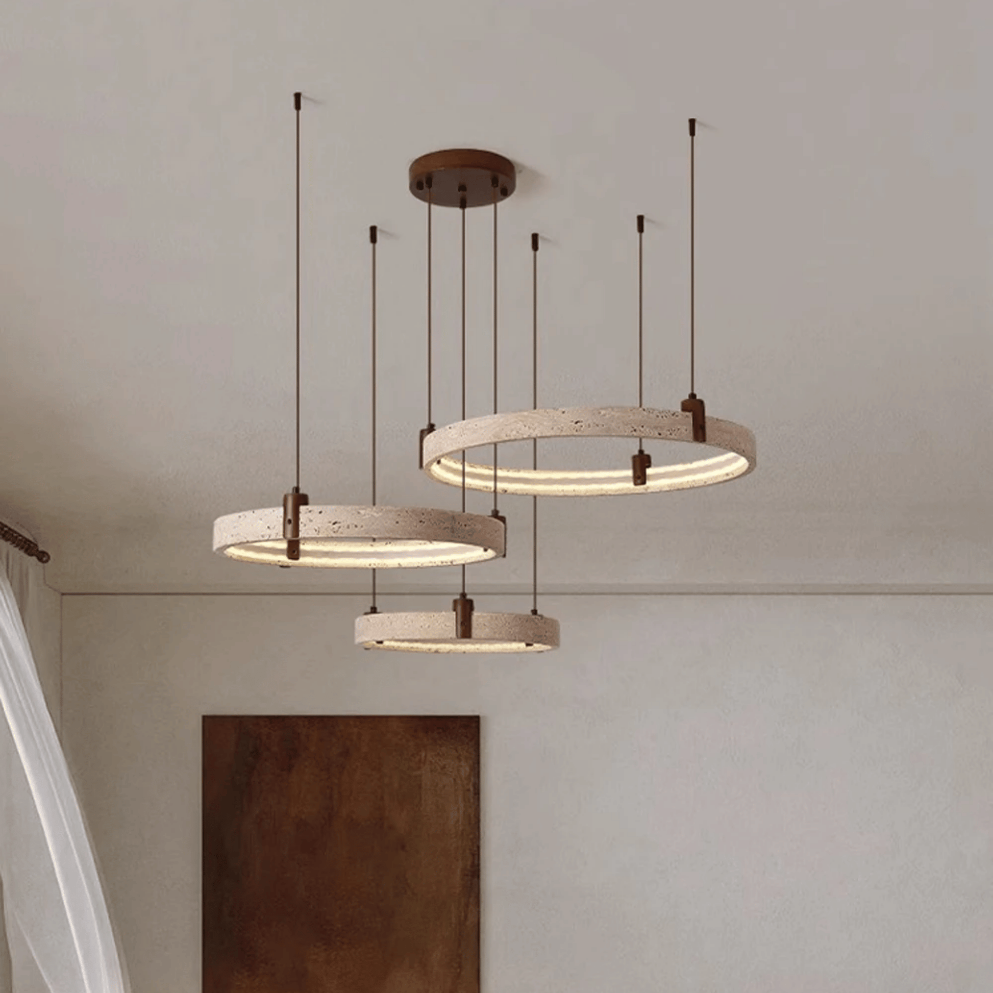 Three circular pendant lights hanging from the ceiling with a neutral background.