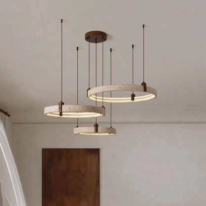 Three circular pendant lights hanging from the ceiling with a neutral background.