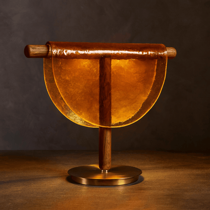 Decorative object with wooden handle and base on a dark background