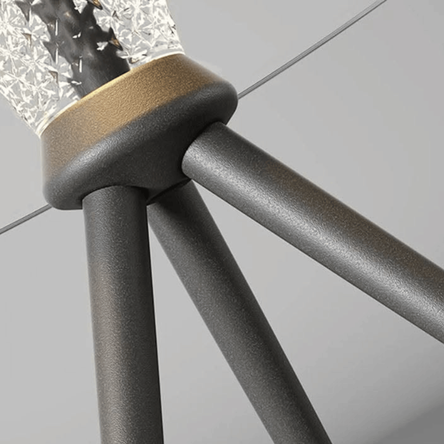 Close-up of a tripod with a textured light source on a gray background