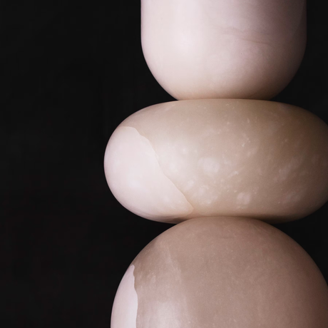 Three stacked stones on a black background