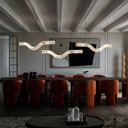 Modern dining room with a long table, chairs, and decorative wall art.