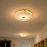 Ceiling light fixture with marble-like finish in a room setting